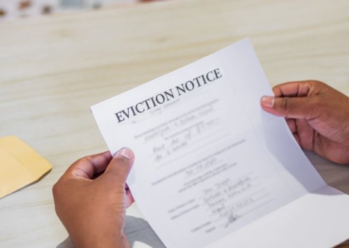 Photo of a person holding an eviction notice