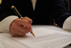 Photo of person signing a document