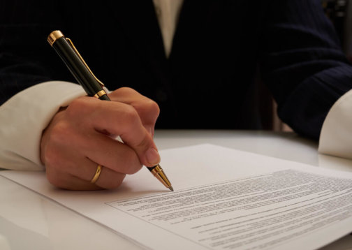 Photo of person signing a document