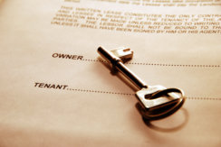 Photo of landlord-tenant lease agreement with key
